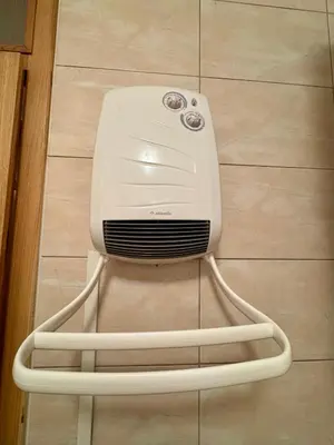 a white hair dryer sitting on a tile floor at Apartman Zimski Kutak in Kupres