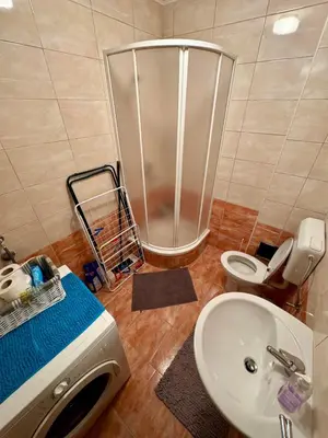 a bathroom with a shower and a sink and a toilet at Apartman Zimski Kutak in Kupres