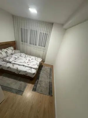 a bedroom with a bed in a white room at Stan na dan Jelah in Jelah