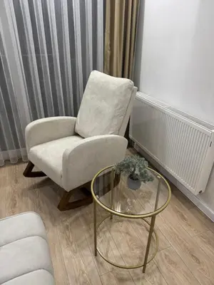a living room with a chair and a glass table at Stan na dan Jelah in Jelah