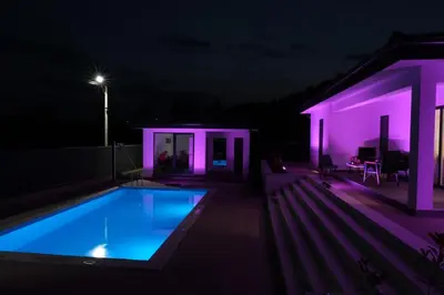 a house with a swimming pool at night at Luxury Villa JAKOV in Banja Luka