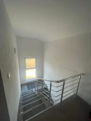 an empty room with stairs and a window at Porodični mir in Bugojno