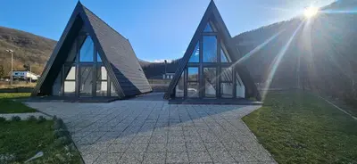 a small building with the sun shining behind it at Golden Spa A-Frame 2 in Bihać