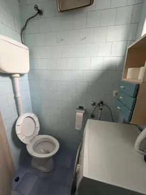 a small bathroom with a toilet and a sink at Apartman Andja in Laktaši