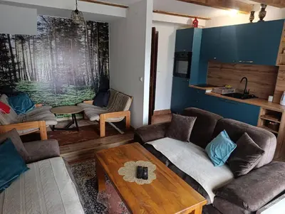 a living room with a couch and a table at Vikendica SANA Vlašić in Šišava