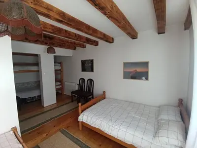 a bedroom with a bed and a chair at Vikendica SANA Vlašić in Šišava