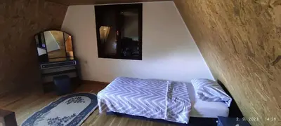 a small bedroom with a bed and a mirror at Vikendica Popovic in Doboj