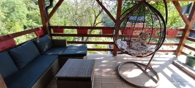 a porch with a swing and a bench and a swingoit at Vikendica Popovic in Doboj