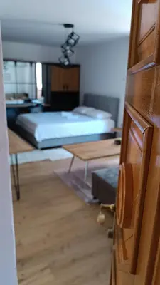 a room with a bed and a room with a door at Galija in Velika Kladuša