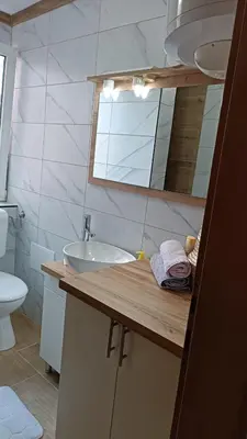 a bathroom with a sink and a toilet and a mirror at Galija in Velika Kladuša