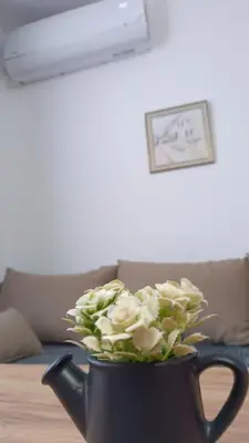 a bouquet of white roses in a black pot on a table at Galija in Velika Kladuša