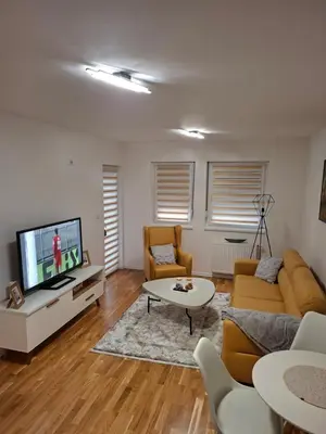 a living room with a couch and a tv at Apartman Idea 2 in Tuzla