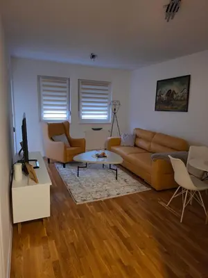 a living room with a couch and a table at Apartman Idea 2 in Tuzla