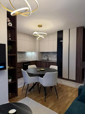 a kitchen and dining room with a table and chairs at Stelmar Apartment in Banja Luka