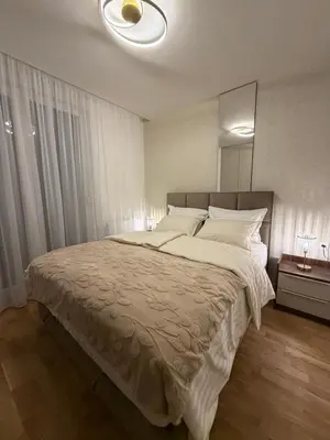 a bedroom with a large bed with a large mirror at Stelmar Apartment in Banja Luka