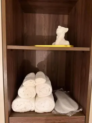 a group of towels in a wooden closet at Stelmar Apartment in Banja Luka