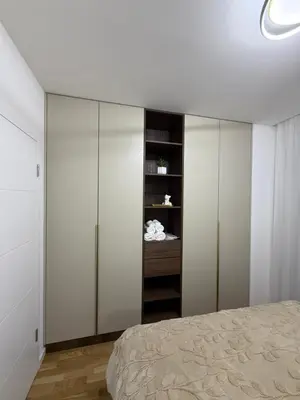 a bedroom with white cabinets and a bed at Stelmar Apartment in Banja Luka