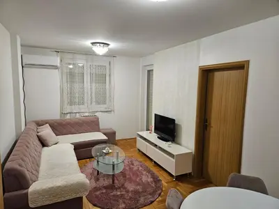 a living room with a couch and a tv at Apartman Magic in Banja Luka