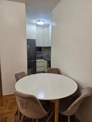 a kitchen with a white table and chairs at Apartman Magic in Banja Luka