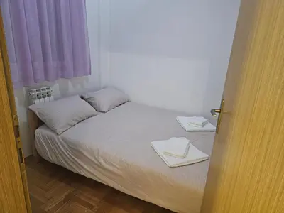 a bedroom with a bed with two towels on it at Apartman Magic in Banja Luka