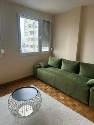 a living room with a green couch and a table at Apartman Lagom in Banja Luka
