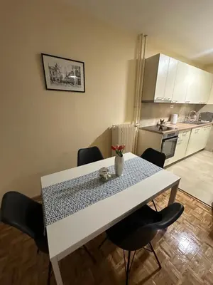 a dining room table with chairs in a kitchen at Apartman Lagom in Banja Luka