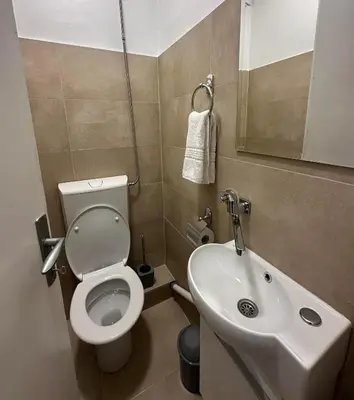 a small bathroom with a toilet and a sink at Apartman Lagom in Banja Luka