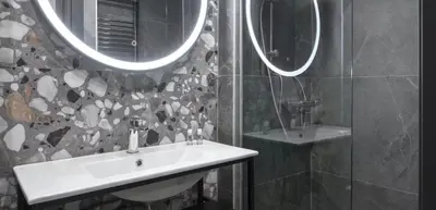 a bathroom with a sink and two mirrors at Nikstudio in Banja Luka