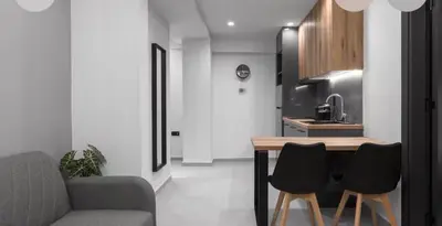 a kitchen with a table and chairs in a room at Nikstudio in Banja Luka