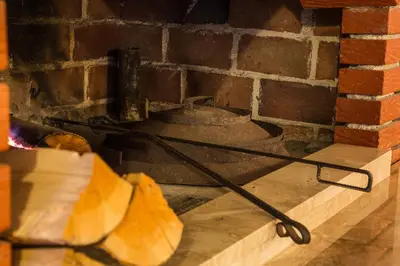 an old bell in a brick fireplace at Hotel Knez in Kupres