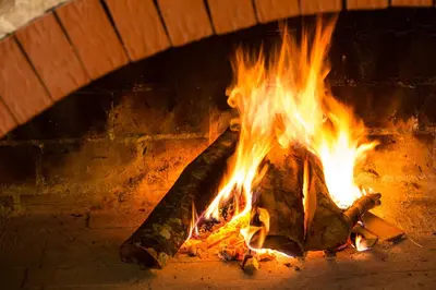 a fire in a brick oven with flames at Hotel Knez in Kupres