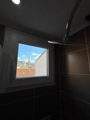 a window in a bathroom with a view of a building at Sanak in Ivišovo Greblje