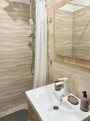 a bathroom with a sink and a shower at Sanak in Ivišovo Greblje