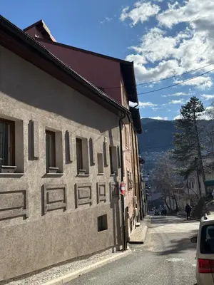 a building with windows on the side of a street at Sanak in Ivišovo Greblje