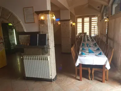 a dining room with a table with blue dishes on it at Hotel Split in Usora