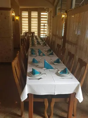 a long table with plates and napkins on it at Hotel Split in Usora