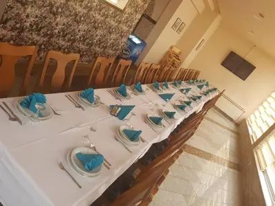 a long table with blue napkins on top of it at Hotel Split in Usora