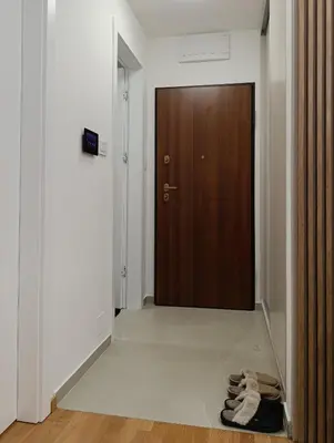 a pair of shoes sitting on the floor in front of a door at Apartman Andrija in Banja Luka