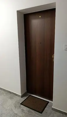 a door in a room with a mat in front of it at Apartman Andrija in Banja Luka