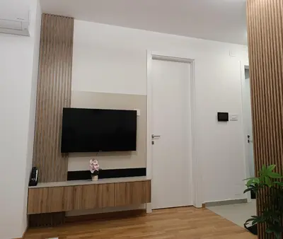 a living room with a flat screen tv on a wall at Apartman Andrija in Banja Luka