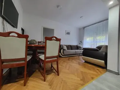 a living room with a table and a couch at Stan na dan Gradiska