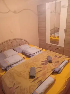 a bedroom with two beds with towels on it at Stan na dan Gradiska
