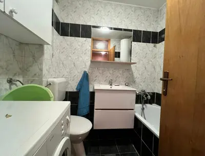 a bathroom with a toilet and a sink and a tub at Stan na dan Gradiska