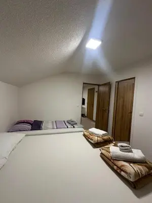 a bedroom with a bed with two towels on it at Apartments Aventra in Visoko