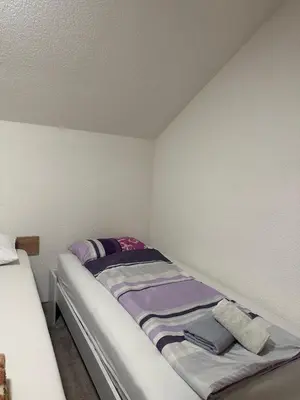 a small room with a bed in the corner at Apartments Aventra in Visoko