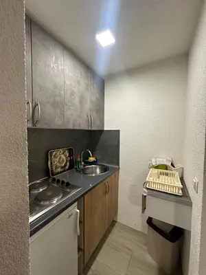a small kitchen with a sink and a counter at Apartments Aventra in Visoko
