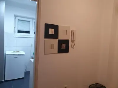 a bathroom with black and white pictures on the wall at Apartman Magelan in Bosanska Gradiška