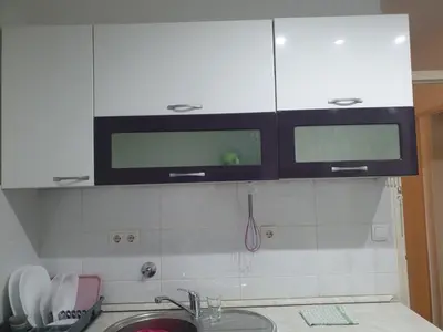 a kitchen with white cabinets and a sink at Apartman Magelan in Bosanska Gradiška
