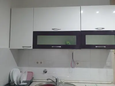 a kitchen with white cabinets and a sink at Apartman Magelan in Bosanska Gradiška