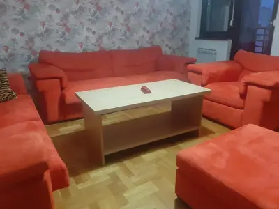 a living room with orange couches and a coffee table at Apartment No1 in Banja Luka